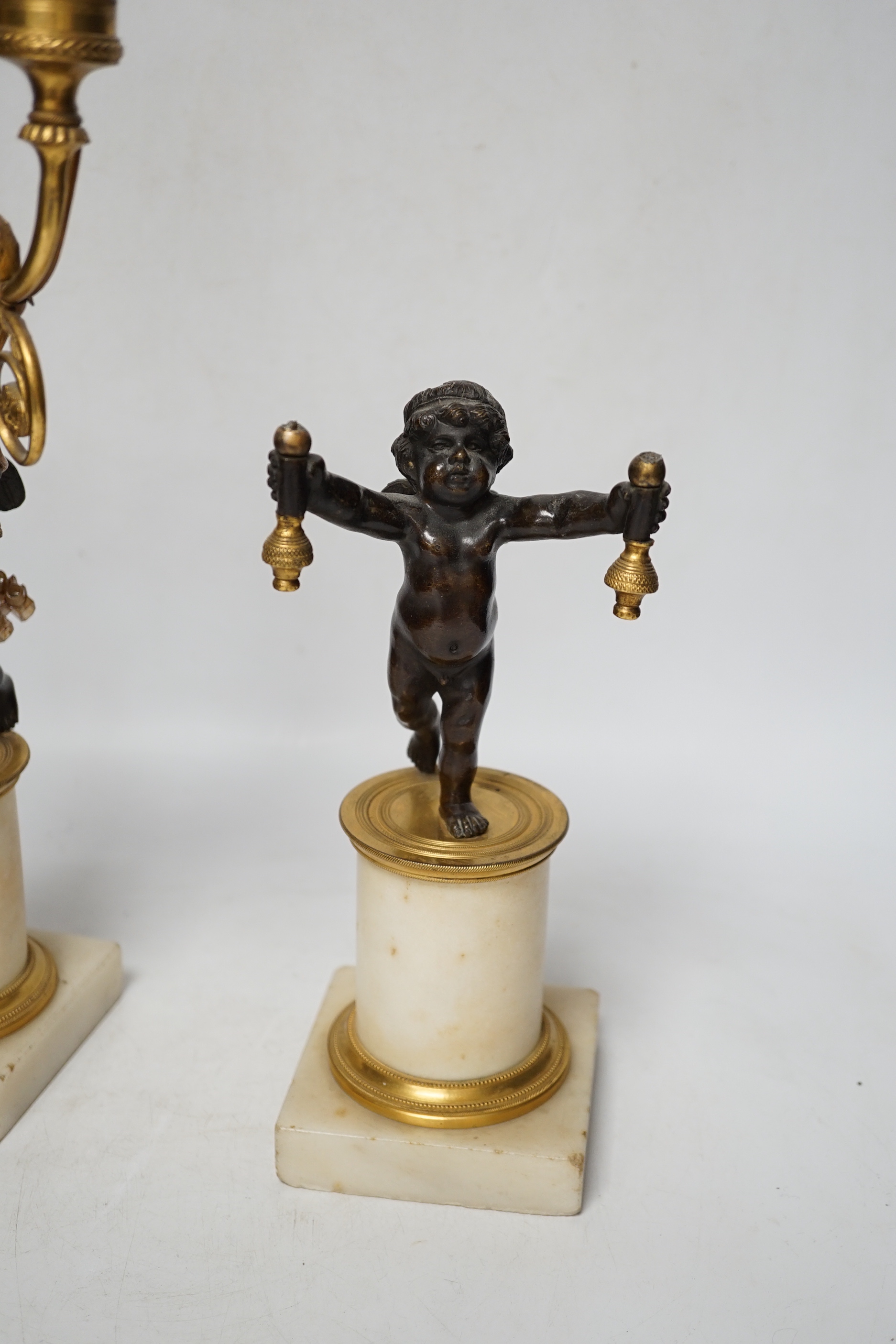 A pair of Louis XVI style bronze, ormolu and alabaster cherub lamps, 42cm high (one a.f.)